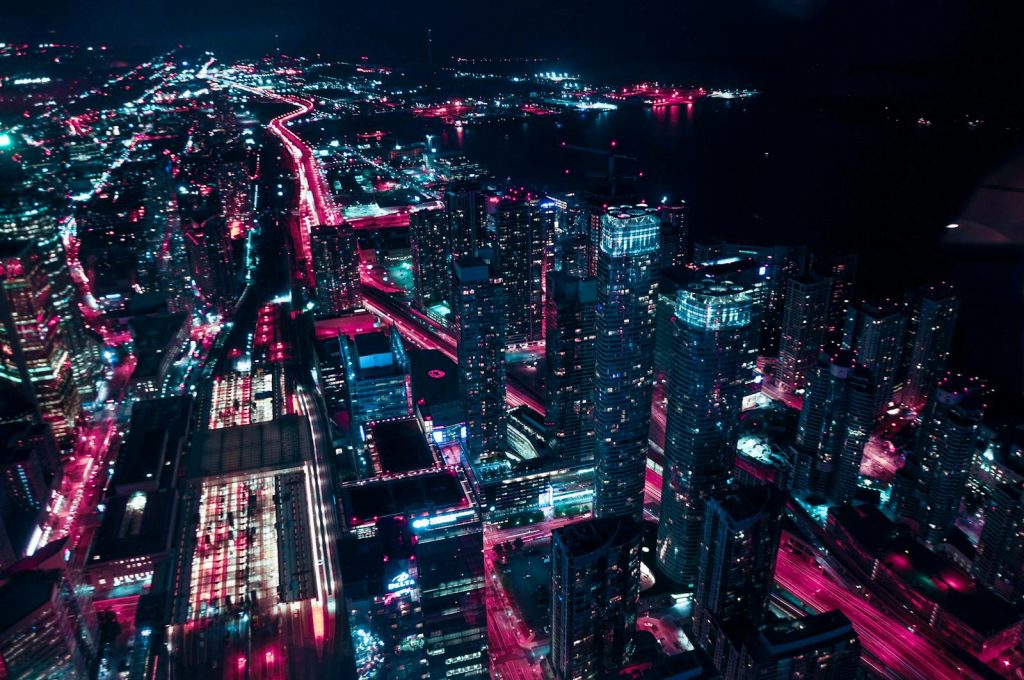 Explore the dazzling nightscape of Toronto's illuminated skyline from above, showcasing vibrant urban life.