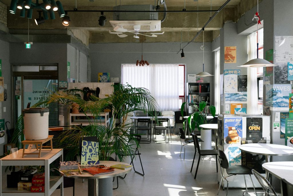 A light-filled cafe interior with plants.